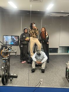 a group of people standing in front of a mirror