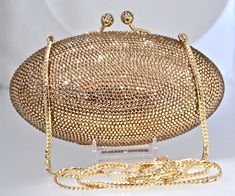 "Heart- stoppingly beautiful design and sparkle! These Evening Formal Oval shaped Purses in gold, gold with pearls and ALL CLEAR will be the talk of town!! Each is handmade. Each takes months to complete, one crystals at a time! Here at Etsy, we offer you the best quality at discounted prices, a fraction of what high priced retailers charge! These are evening bags that are fully covered in genuine, very fine, small sized Swarovski Crystals from Austria! One purse is in all CLEAR CRYSTALS, One is Elegant Bedazzled Formal Jewelry, Elegant Formal Bedazzled Jewelry, Gold Sparkling Evening Bag For Formal Occasions, Gold Crystal Evening Bag For Wedding, Glamorous Gold Sparkling Clutch, Glamorous Gold Sparkling Evening Bag, Gold Crystal Evening Bag With Bling, Sparkling Gold Clutch For Events, Elegant Gold Sparkling Evening Bag