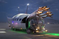 an airplane with its wings extended and lights on