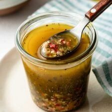 a spoon in a jar filled with food