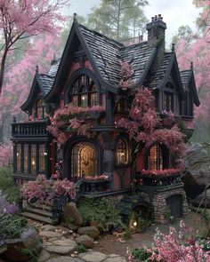 a pink house with lots of windows and flowers on the front porch is surrounded by trees