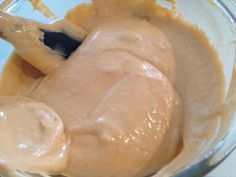 a glass bowl filled with peanut butter and sauce