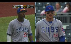 two baseball players standing next to each other on a field