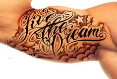 an arm with writing on it that says live, love, and dream written in cursive letters