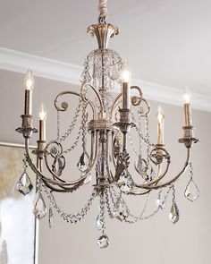 a chandelier hanging from the ceiling in a room