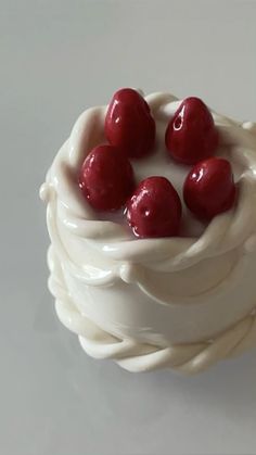 there are cherries on top of the whipped cream in this cupcake cake,