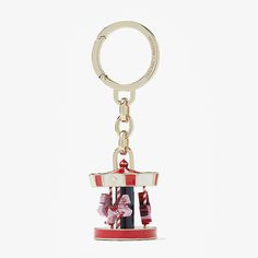 a red and white carousel keychain on a white background