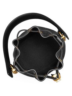 Tory Burch's bucket bag flaunts the label's signature monogram print and luxe leather trim. Shining goldtone hardware and a drawstring closure complete the look..Leather top handle.Removable crossbody strap.Leather drawstring closure.60% cotton/40% polyester.Polyester lining.Cow leather trim.Imported.SIZE.Strap, about 21.5' drop.7'H x 5.5'L x 4.25'D.ABOUT THE BRAND.Since debuting her brand in 2004, New York-based designer Tory Burch has made an impact on the fashion world with her handbags and s Tory Burch Bucket Bag, T Monogram, Mini Bucket Bags, Mini Bucket, Monogram Prints, Tory Burch Bags, Bags Tote, Leather Bucket Bag, Tory Burch Bag