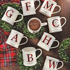 six coffee mugs with the letters g, m, and w on them