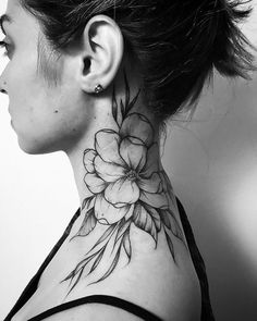 a woman with a flower tattoo on her neck and behind her ear is a black and white photo