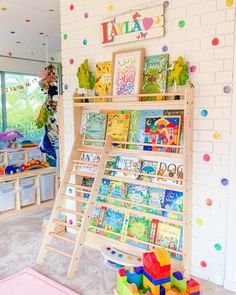 a child's playroom with toys and books on the shelves in front of it