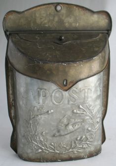 an old fashioned metal post box with the word post on it's front and bottom