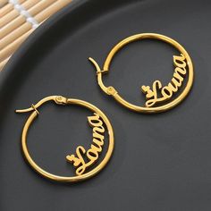 Lets make our lives more beautiful with custom/personalized items. This can bring you a lot of joy when you see your name or your loved once name on the item. Having your personal touch on a piece of jewelry really makes a difference. Item:- Old English Name Earrings Hoop Diameter:- 20-30-50-60-70 MM Metal:- Stainless Steel Finished:- Platinum-Rose Gold-Gold We have make 2 different name on1pair Please Explain your Name & Font No. On Personalization Box. Like This- Abdul Font #1 Processing a Custom Name Small Hoop Earrings As Gift, Custom Name Round Earrings For Personalized Gift, Custom Name Earrings For Personalized Gift, Customizable Round Earrings For Gift, Personalized Dangle Hoop Earrings As Gift, Customizable Hoop Earrings Gift, Personalized Dangle Hoop Earrings For Gifts, Customizable Hoop Earrings For Gifts, Personalized Small Hoop Earrings As Gift