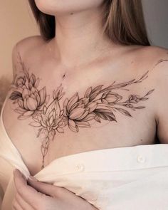 a woman with a flower tattoo on her chest