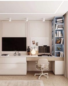 a home office with a desk, chair and television on the wall in front of bookshelves