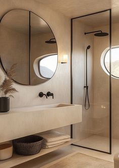 a bathroom with two round mirrors on the wall