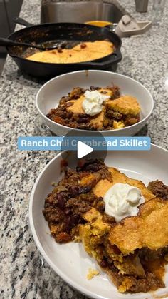 two white plates filled with food sitting on top of a counter next to each other