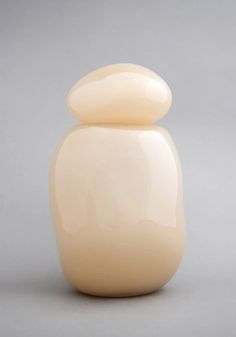 a white vase sitting on top of a table