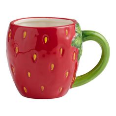 a ceramic strawberry mug with green handles