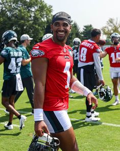 a football player is smiling on the field