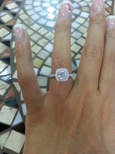 a woman's hand with a diamond ring on it