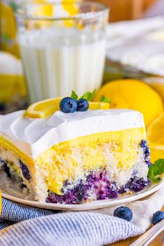 a slice of lemon blueberry cake on a plate with a glass of milk in the background