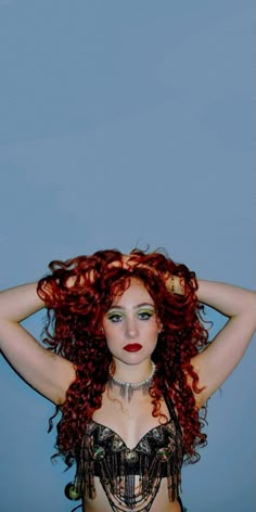 a woman with red hair wearing a bra