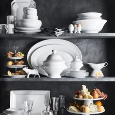 white dishes and plates on shelves in a kitchen