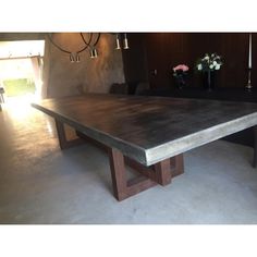 a large table with two candles on it in the middle of a living room area