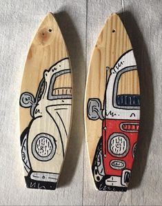 two wooden surfboards with cars painted on them