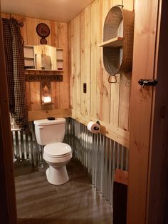 a bathroom with wood paneling and a toilet