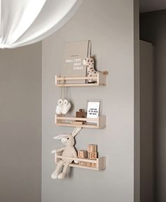 three wooden shelves with stuffed animals on them in a nursery or kids's room