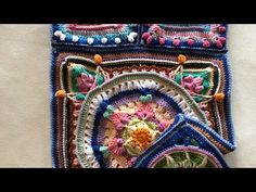 a close up of a crocheted piece of cloth with flowers on it and beads around the edges