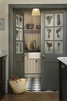 an open door leading to a kitchen with pots and pans on the wall