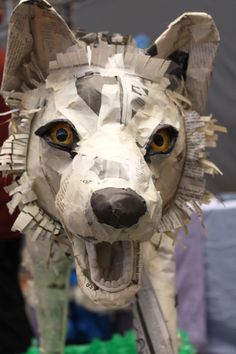 a sculpture of a dog made out of newspaper strips and paper machs is shown