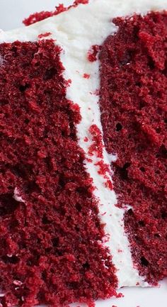 a slice of red velvet cake with white frosting