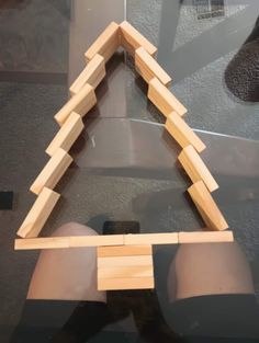 a wooden triangle on top of a glass table