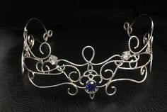 I wanted to create a magical and beautiful bohemian renaissance crown, also called a circlet, in all sterling silver, to which I've designed substantially to last a lifetime of enjoyment. Inspired by Lord of the Rings/Middle Earth with an Elvish Celtic feel, this headpiece can be worn not only for a bridal theme, but at any Renaissance event as well. This piece fits back towards the ears and has elastic fasteners to position in place for a secure and snug fit for your head shape. You will need t Bohemian Wedding Jewelry With Artistic Design, Handmade Elegant Festival Headpiece, Elegant Handmade Festival Headpiece, Whimsical Crown-shaped Jewelry For Weddings, Handmade Bohemian Crown Headpiece, Bohemian Handmade Crown Headpiece, Handmade Fantasy Crown Jewelry, Handmade Fantasy Wedding Headpieces, Fantasy Handmade Wedding Headpieces