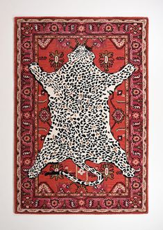 an animal - print rug is hanging on the wall