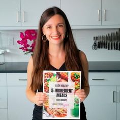 a woman holding up a 5 - ingredient meal book