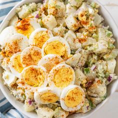 a bowl filled with boiled eggs and garnished with seasoning