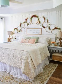 a white bed sitting in a bedroom next to a window