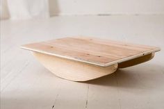 a wooden table sitting on top of a white floor