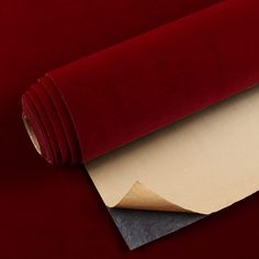 a roll of red velvet paper on top of a table