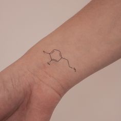 a hand with a tattoo on it that has an image of the structure of a substance