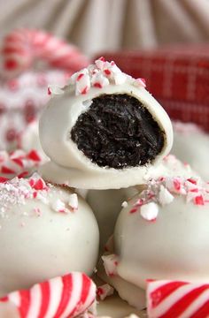 white and red candies are stacked on top of each other with candy canes