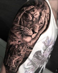 a man with a lion and tiger tattoo on his arm