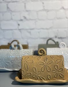 two small purses sitting next to each other on top of a white countertop