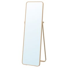 a mirror that is standing up on a stand