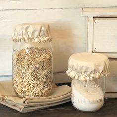 a glass jar filled with oatmeal sitting on top of a wooden table